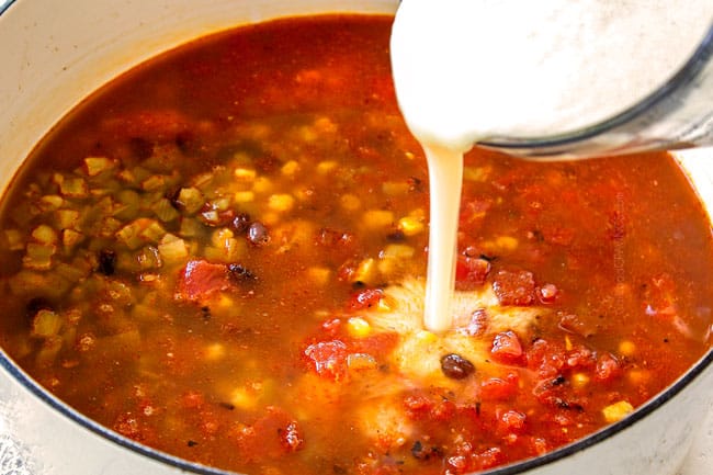 showing how to make Chicken Enchilada Soup by adding masa harina to the soup