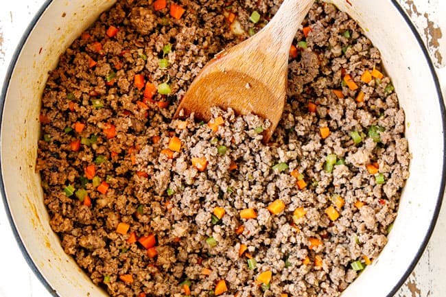 showing how to make easy Baked Ziti with sausage by browning sausage and beef with onions, carrots and celery