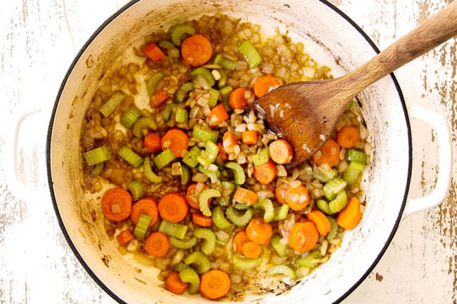 showing how to make chicken stew recipe by sauteing carrots, onions and celery yin a white Dutch oven