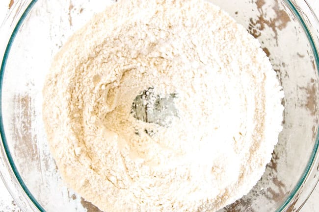 how to make lemon ricotta pancakes by whisking flour, baking powder and sugar together in a glass bowl