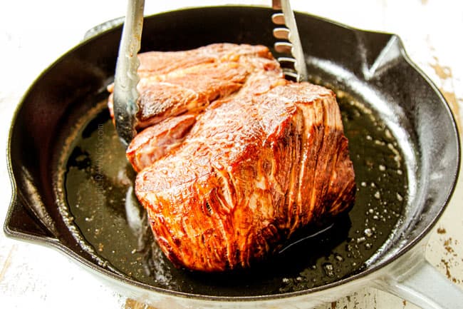 showing how to make Ropa Vieja recipe by searing meat in a cast iron skillet