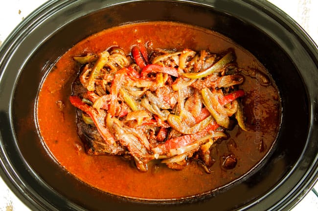 showing how to make crockpot Ropa Vieja recipe by cooking beef until tender in the crockpot