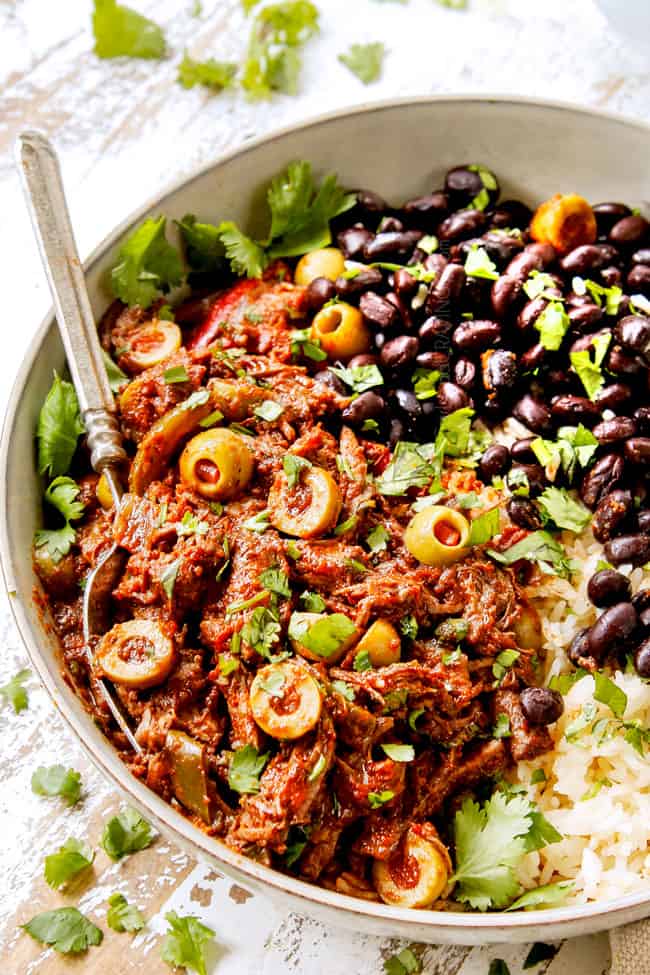 showing how to serve Slow cooker Ropa Vieja by adding to a bowl of rice and beans