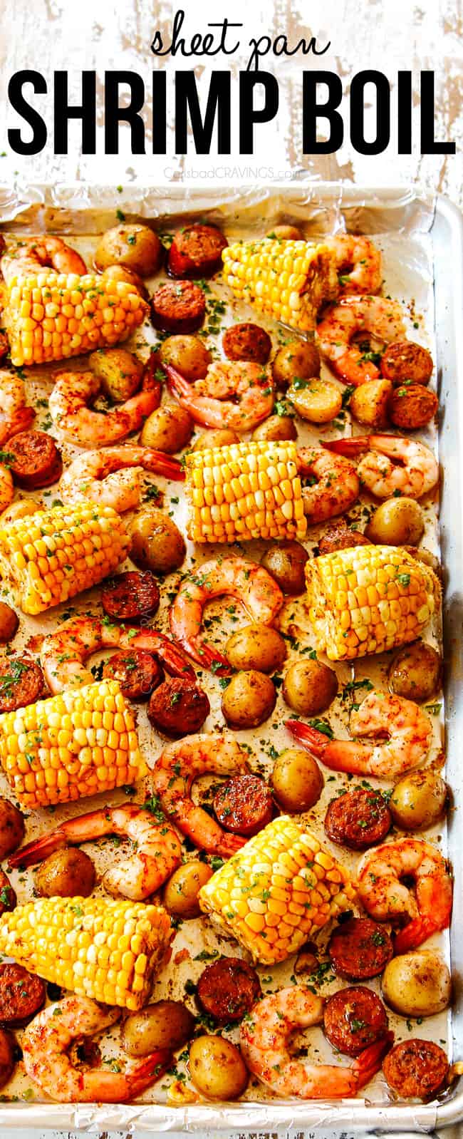 showing how to make shrimp boil recipe by drizzling cooked shrimp, potatoes, corn and sausage with lemon juice and butter