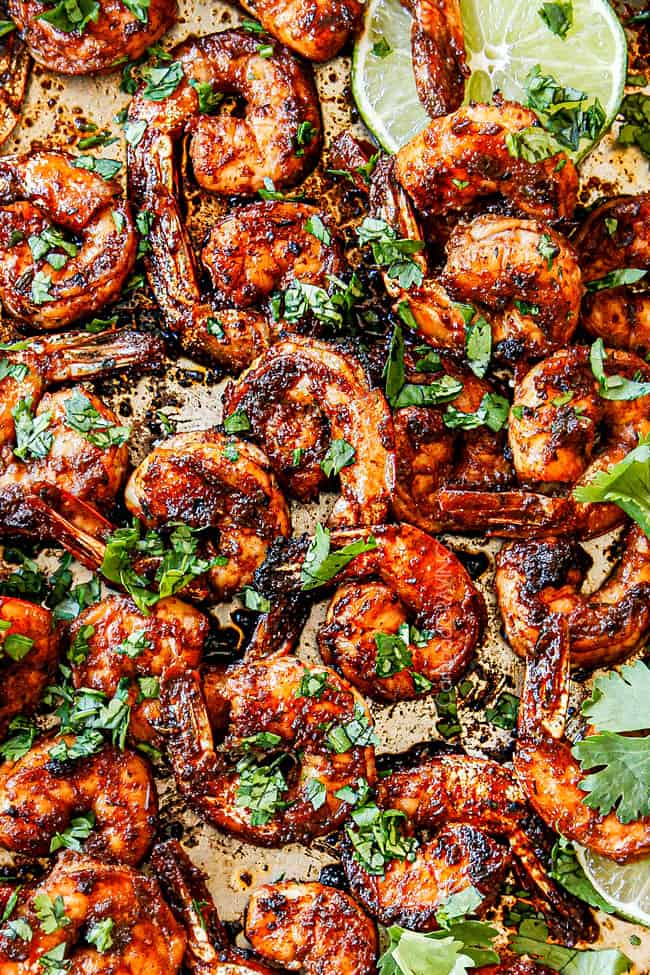 showing how to make jerk shrimp by garnishing with parsley