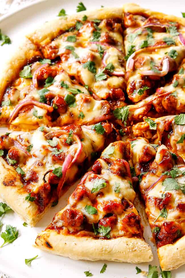 showing how to make BBQ Chicken Pizza by slicing pizza after it's baked
