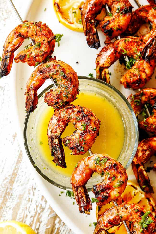 showing how to make grilled shrimp recipe by combing melted butter with lemon and parsley and serving with shrimp