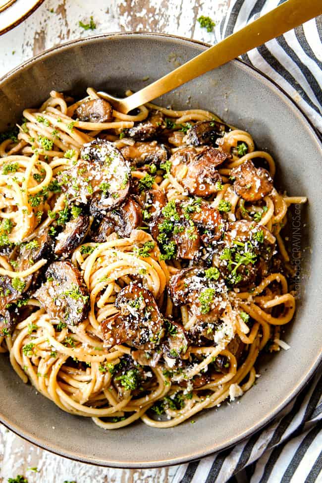 top view showing how to serve Mushroom Pasta by adding pasta to a grey bowl