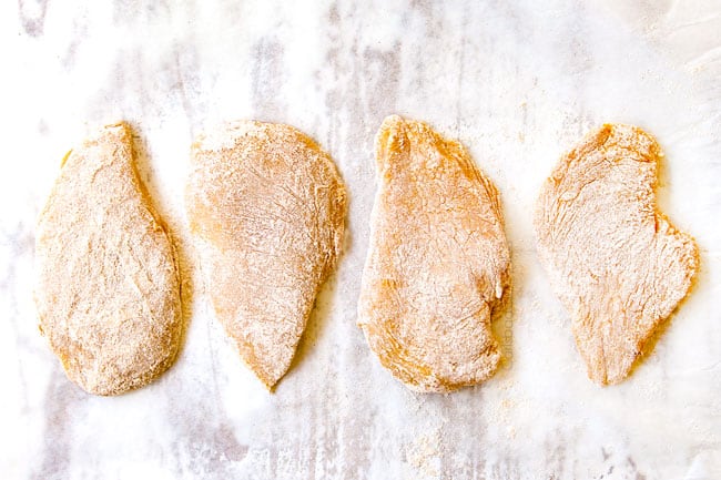 showing how to make coconut chicken by placing 4 dredged chicken fillets to parchment paper