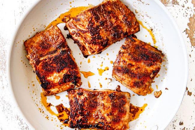 showing how to make fish tacos recipe by cooking fish in a white skillet