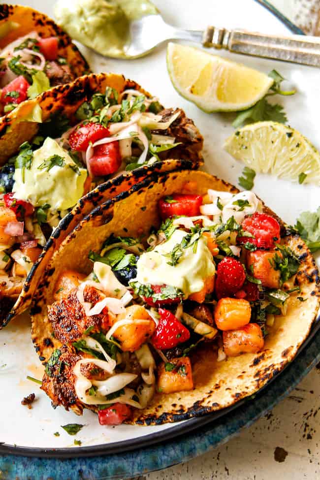 up close of mahi mahi fish taco on a white plate