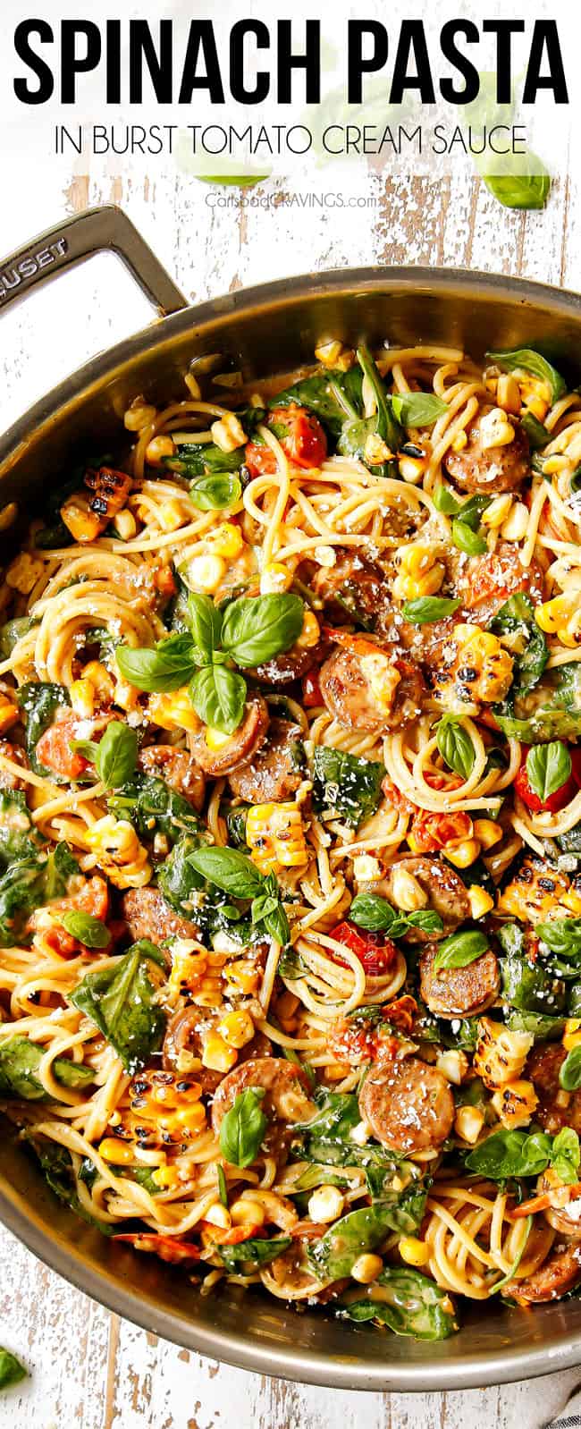 top view of creamy spinach pasta with spaghetti in a  stainless steal skillet