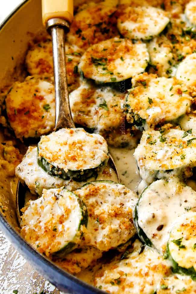 up close of zucchini casserole scooped in a spoon with bread crumbs
