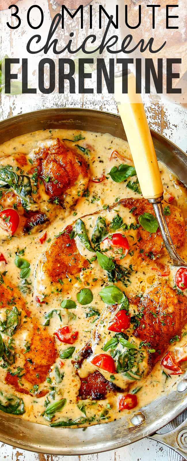 top view of Chicken Florentine in a stainless steel pan with four chicken cutlets in a cream sauce with spinach