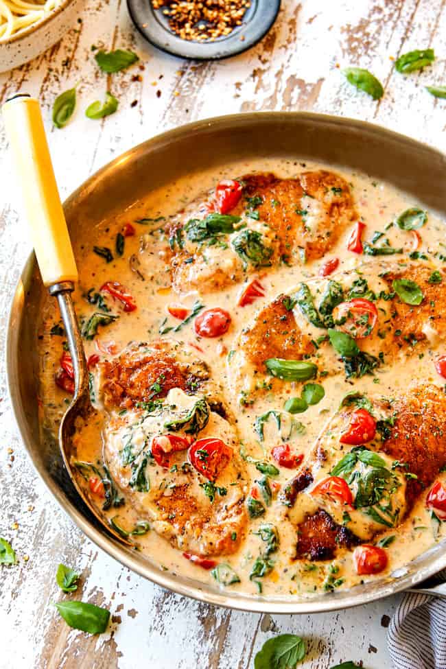 Chicken Florentine recipe in a stainless steel pan in a Parmesan cream sauce with spinach