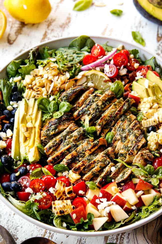 grilled chicken salad recipe in a white bowl with basil vinaigrette