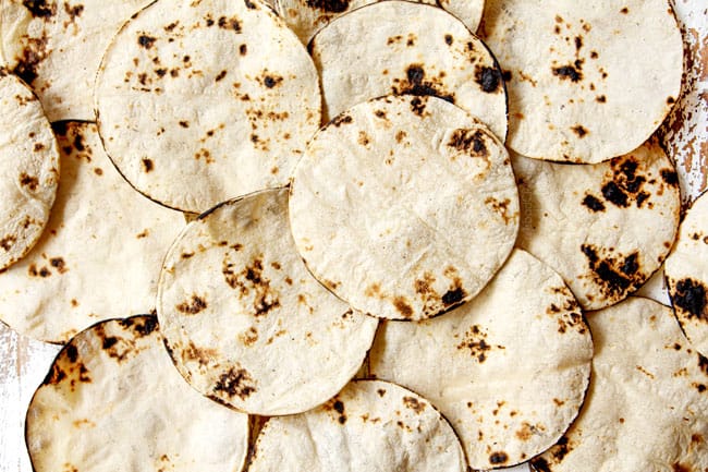 showing how to make King Ranch Casserole by charring corn tortillas until toasted in spots