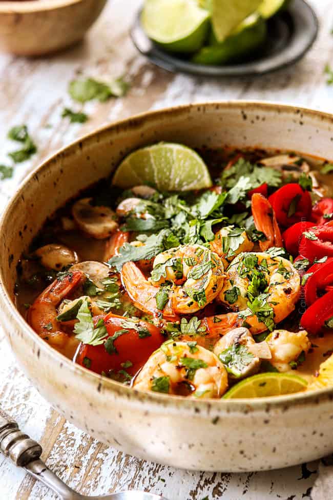 side view of Tom Yum Soup recipe with paste in a bowl with shrimp garnished with cilantro