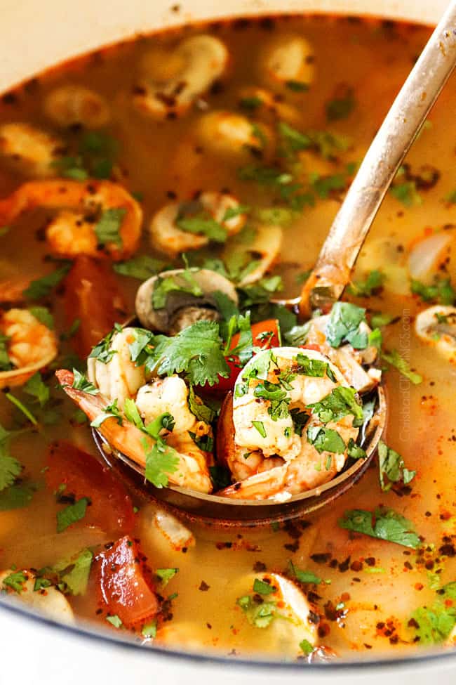 up close of a ladle of Thai Tom Yum Soup