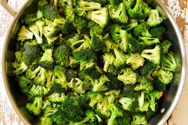 showing how to make chicken broccoli and rice casserole by adding broccoli to a skillet and steaming until tender