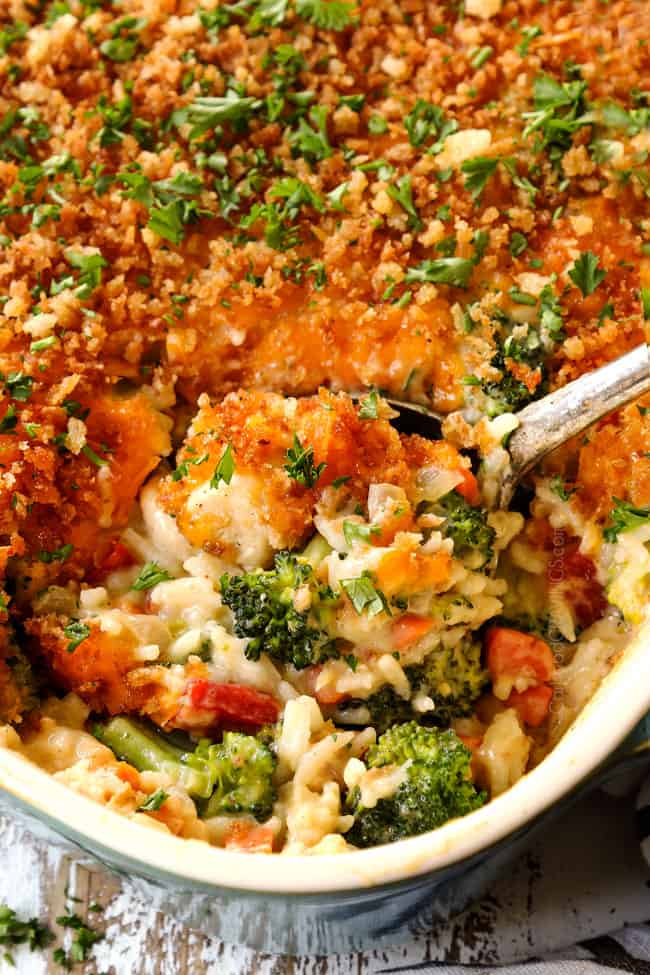 close up of a spoon scooping up chicken broccoli and rice casserole