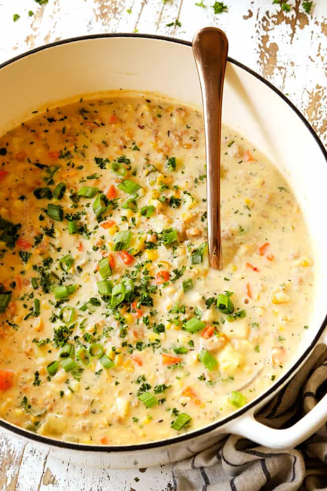 corn chowder in a white soup pot with potatoes