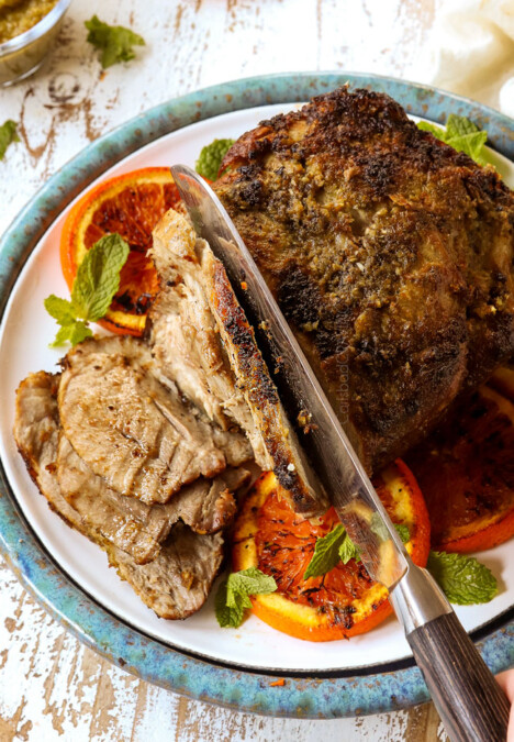 showing how to make mojo Cuban roast pork (lechon asado) by