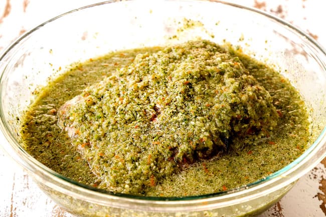 showing how to make Cuban roast pork (lechon asado) by marinating pork in mojo marinade