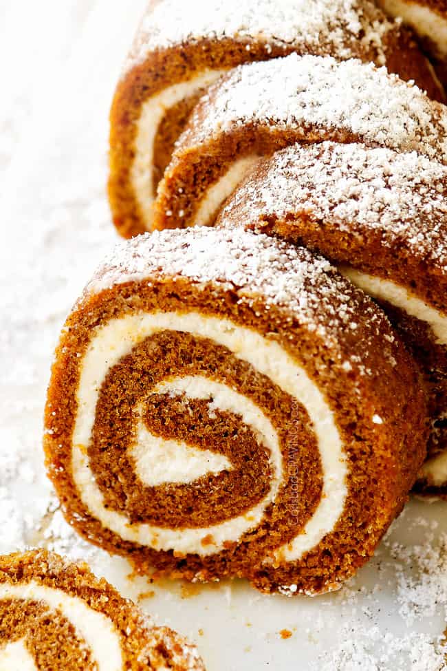 front view of easy pumpkin roll recipe on a white cutting board