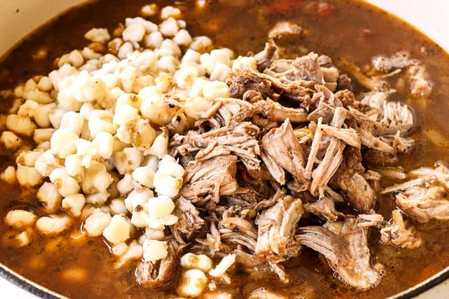 showing how to make pozole by adding hominy and shredded pork back to stew