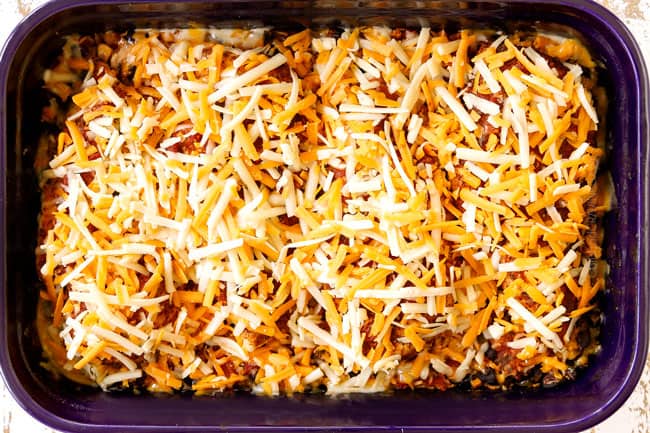 showing how to make salsa chicken by adding cheese on top of the chicken in the 9x13 baking dish