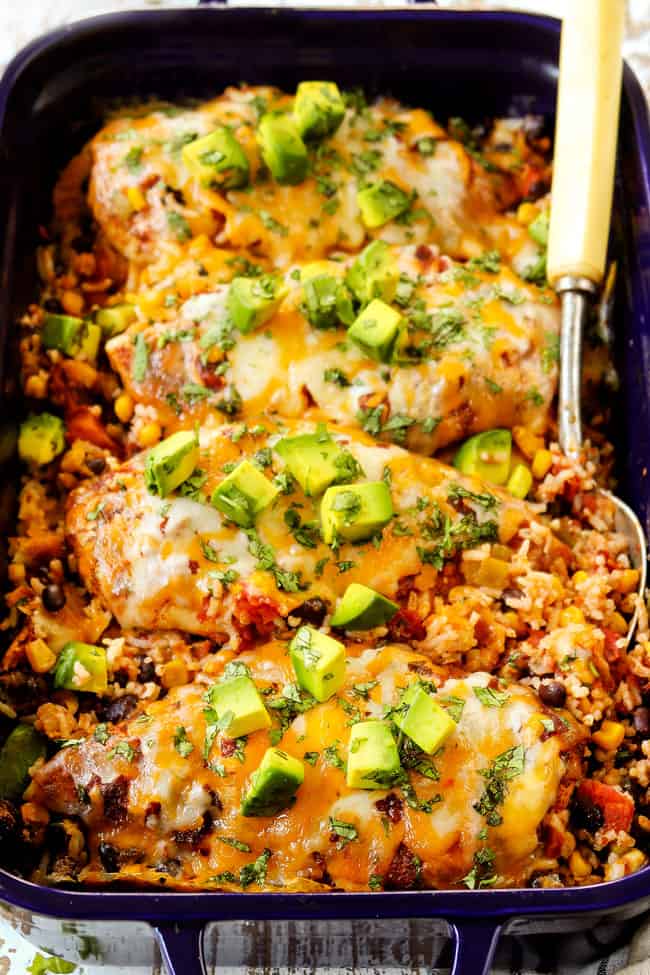 salsa chicken recipe with rice, beans and corn in a blue baking dish
