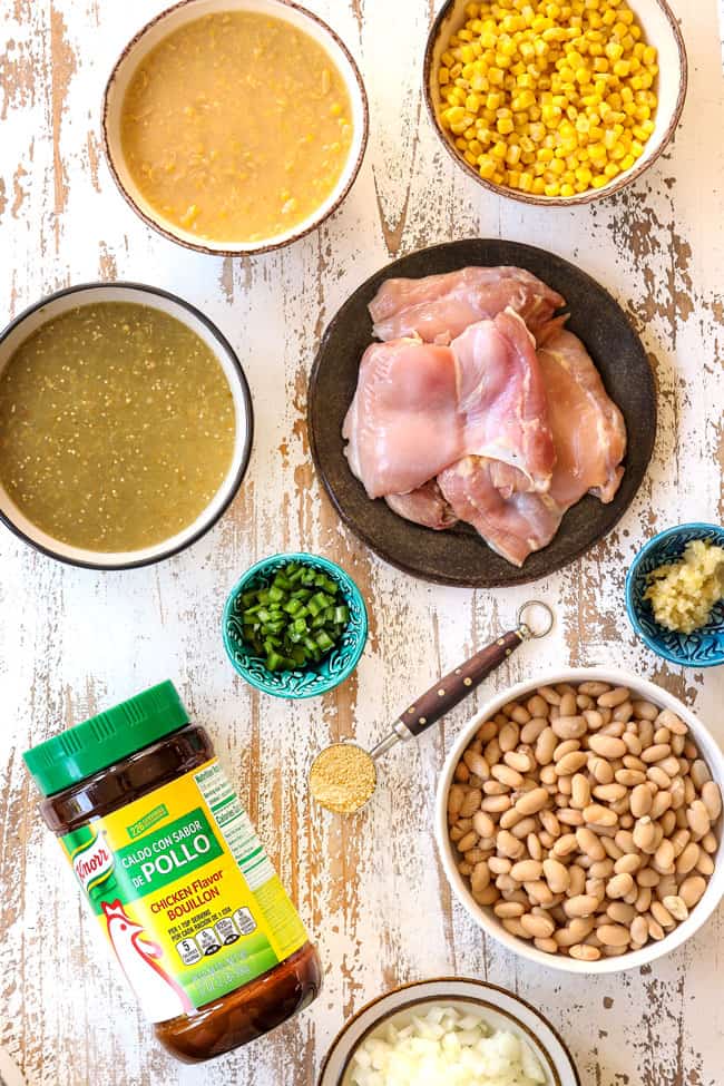showing how to make best white chicken chili recipe with a top view of ingredients: corn, creamed corn, salsa verde, chicken thighs, jalapenos, garlic, white beans and onions