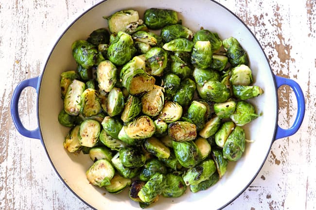 showing how to make creamy Brussel sprouts with bacon by sautรฉing Brussels sprouts with shallots in a pan