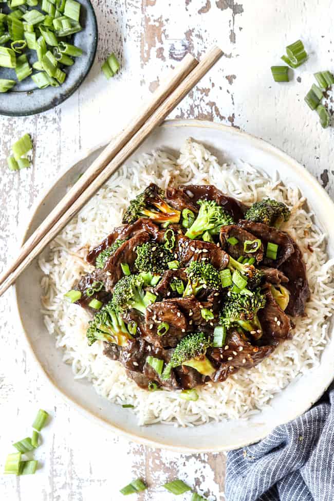 top view of slow cooker beef and broccoli being served over rice