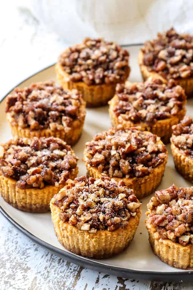 a plate of mini pumpkin cheesecakes