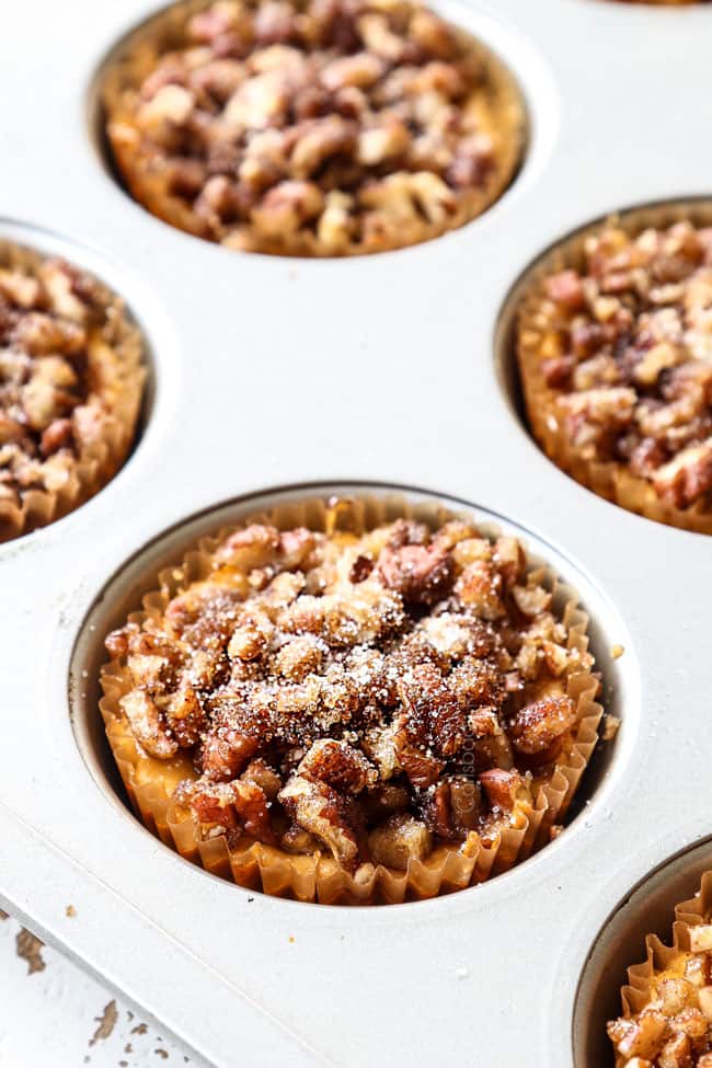 process shot showing how to make mini pumpkin cheesecakes by cooling cheesecake in muffin tin