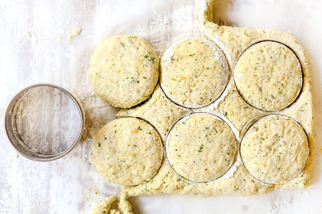 showing how to make chicken pot pie with biscuits by cutting biscuits out from dough