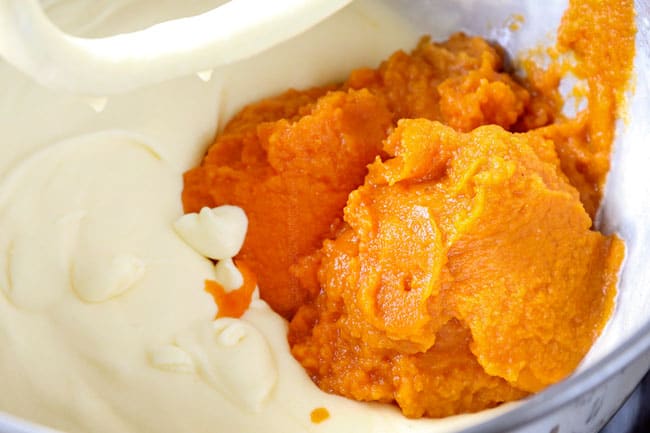 showing how to make pumpkin spice cake recipe by adding pumpkin to egg mixture