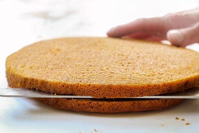 showing how to make pumpkin spice cake by slicing cakes in half horizontally through the middle