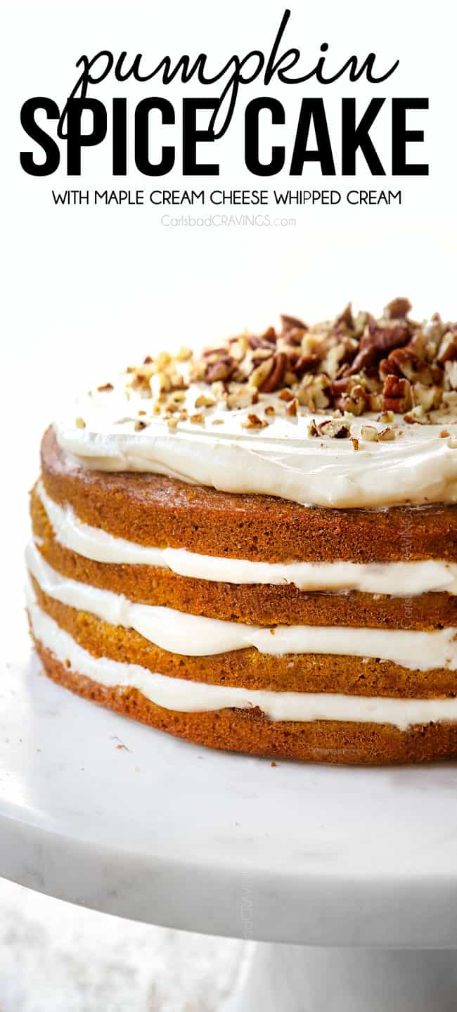 pumpkin spice cake on a pedestal showing the side view of the cake with 4 layers