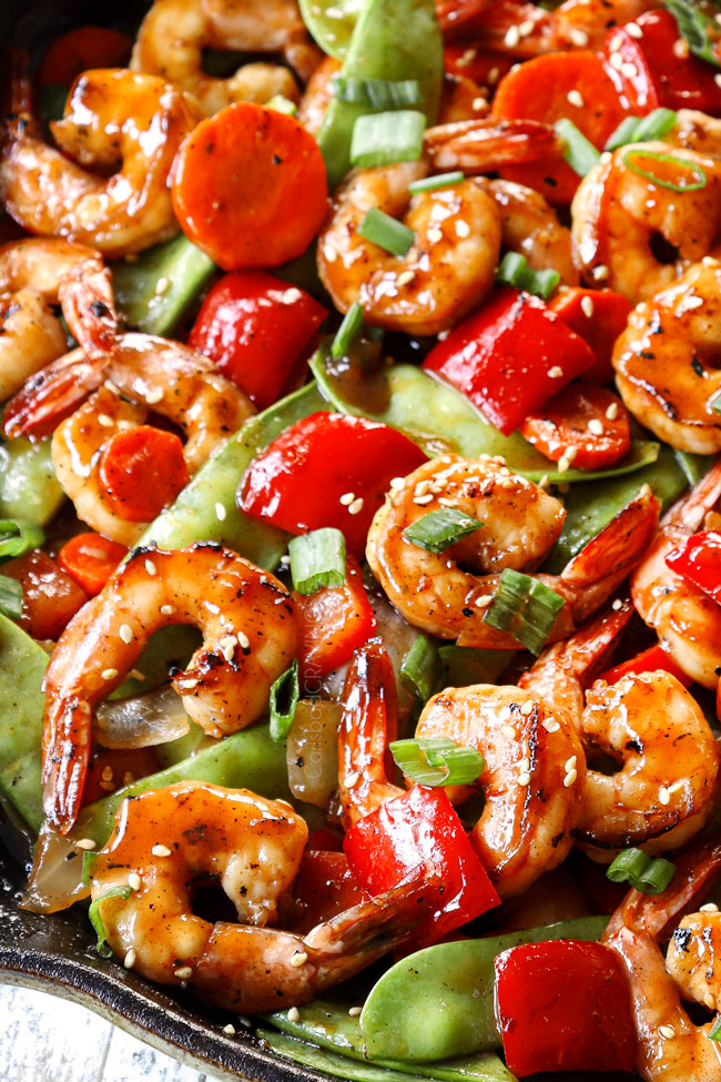 up close side view of shrimp stir fry in a skillet
