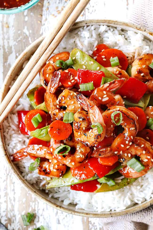top view of shrimp stir fry in a bowl with rice