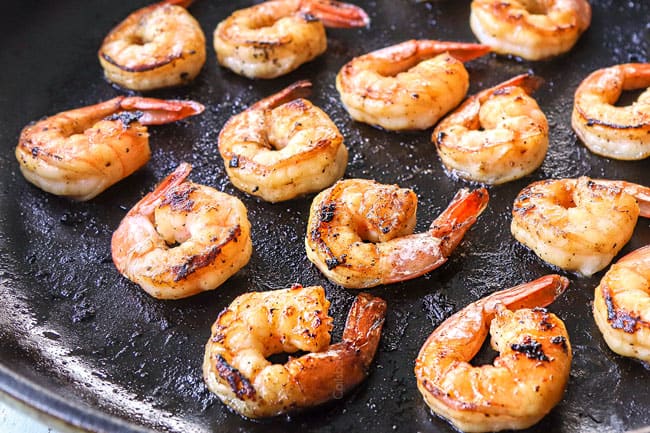 showing how to make shrimp stir fry recipe by cooking shrimp until opaque in a skillet