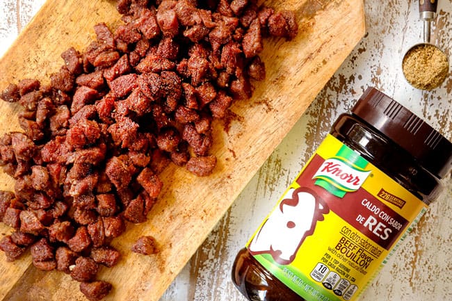 top view of showing how to make steak tacos by tossing in steak taco seasonings