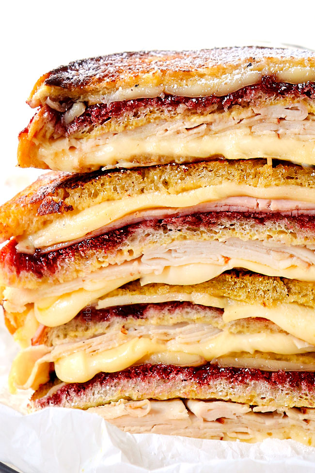 up close of a stack of Monte Cristo sandwiches showing how cheesy they are