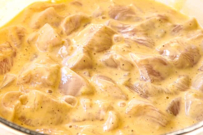 showing how to make chicken nuggets by adding chopped chicken to batter