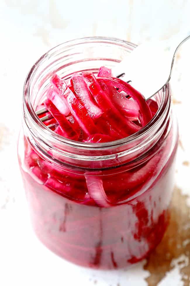 showing how to make rice bowls with a forkful of pickled red onions to top the rice bowls