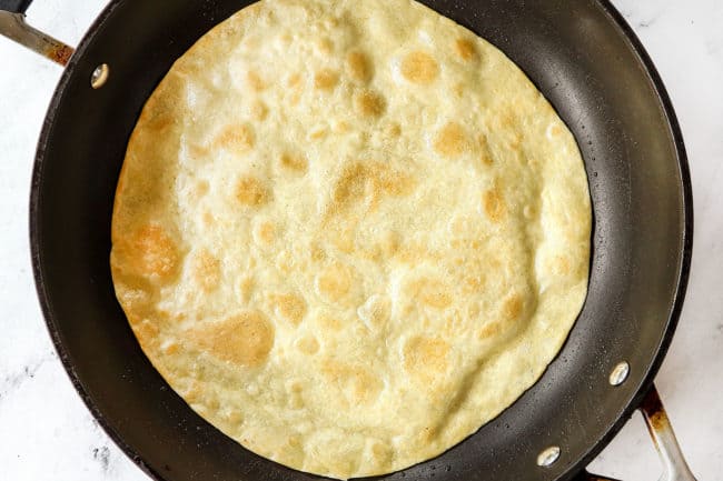 showing how to make taco bowl shells by pan frying a tortilla until golden