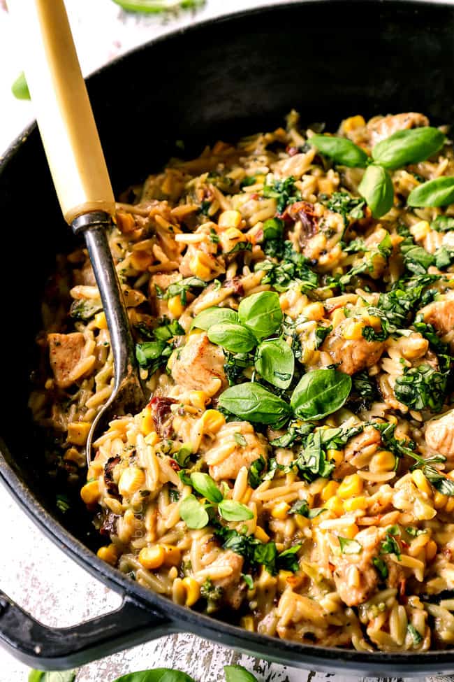 showing how to make basil chicken recipe by stirring basil into chicken